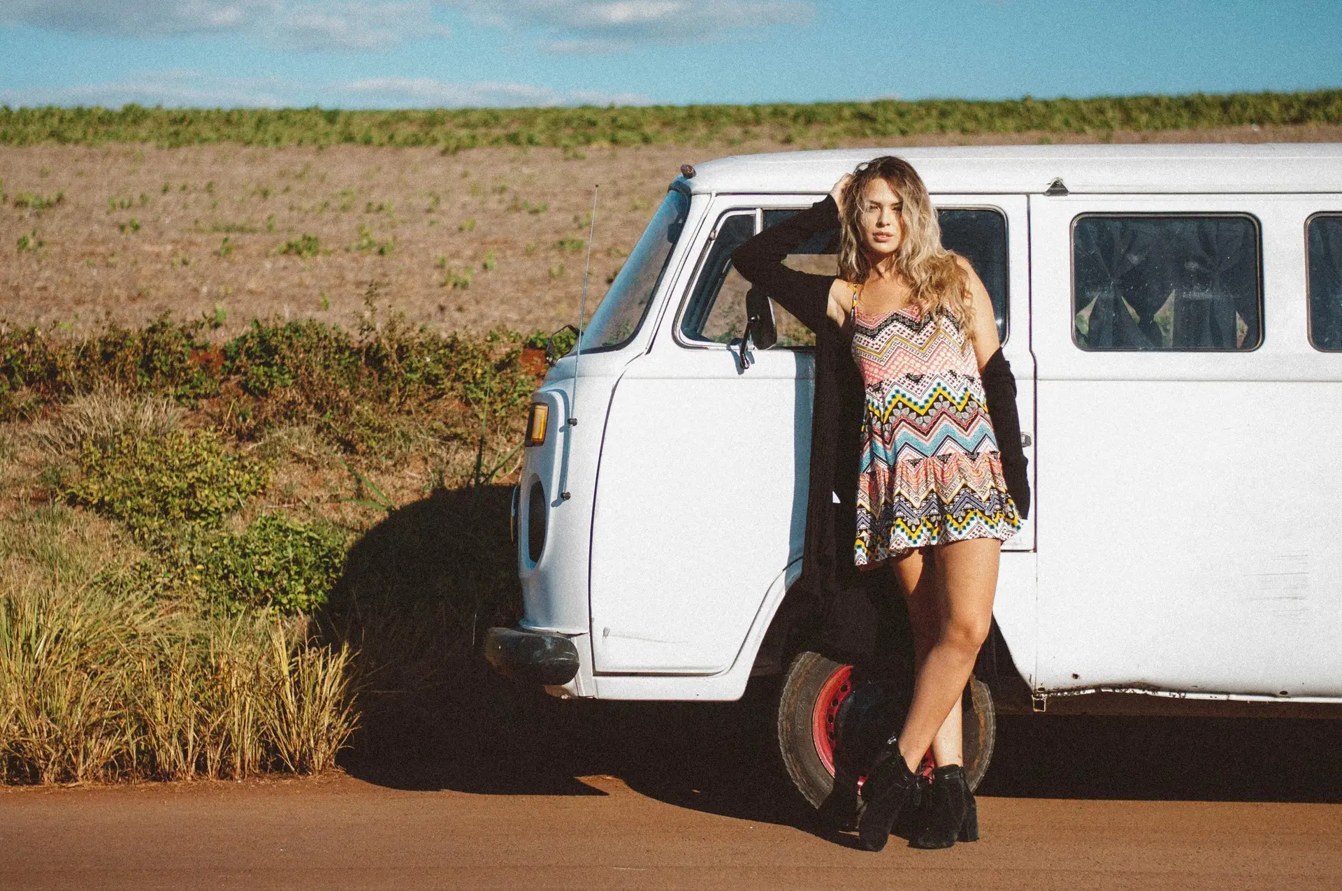 Blonde Woman in Sundress Standing by Van on Road